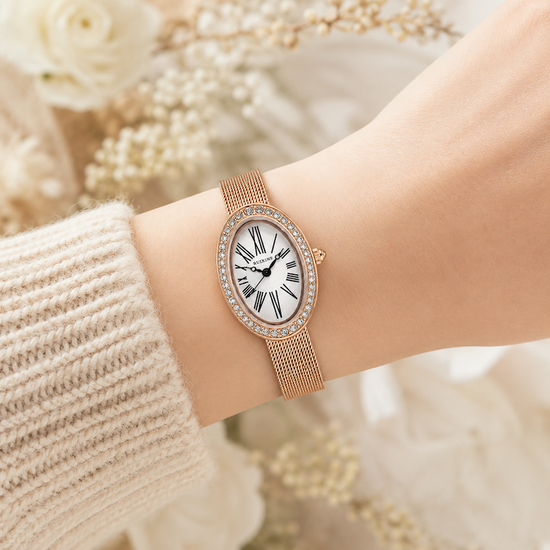 Relógio oval dourado rosé com pulseira de malha e mostrador com algarismos romanos