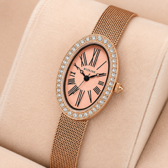 Relógio oval rosé gold com mostrador rosa, bezel com cristais e pulseira de malha metálica