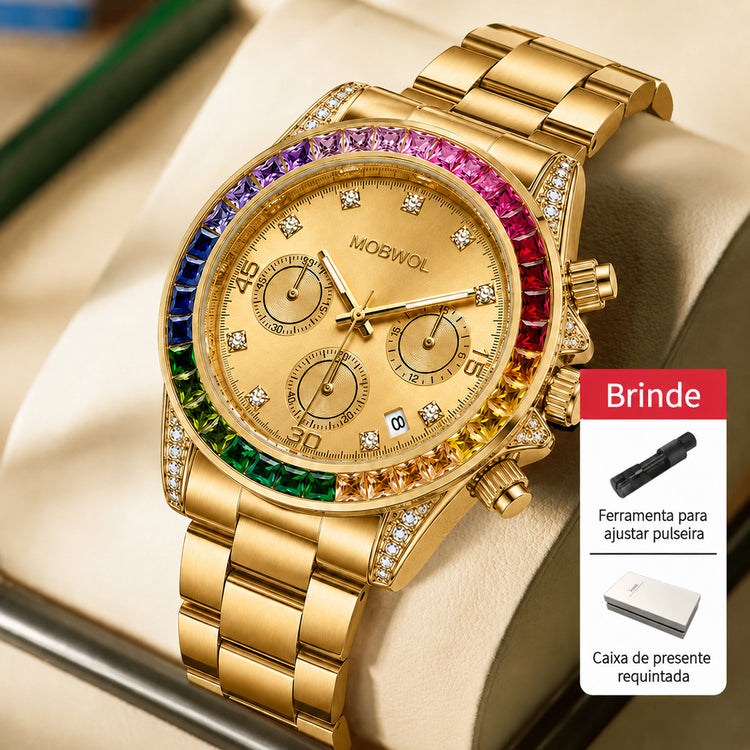 Relógio dourado com mostrador bege e moldura arco-íris, pulseira de metal.