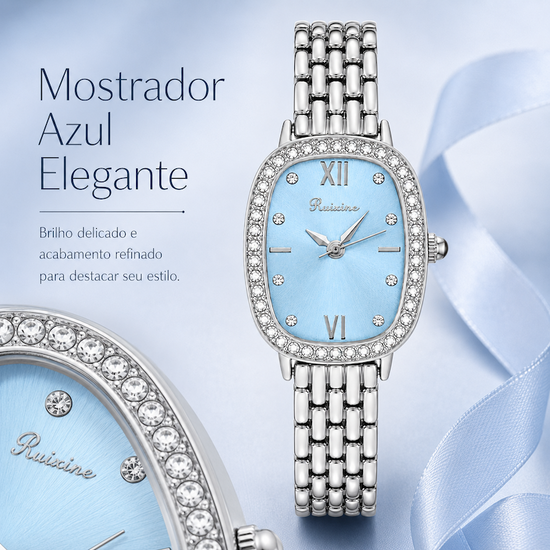 Relógio feminino prateado com mostrador azul claro, aro com strass e pulseira metálica