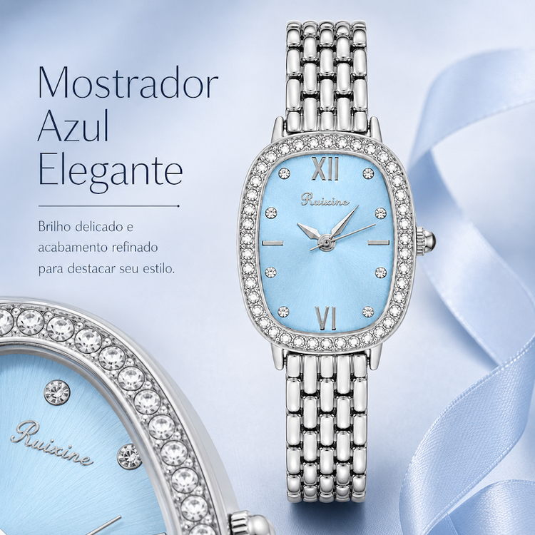 Relógio feminino prateado com mostrador azul claro, aro com strass e pulseira metálica