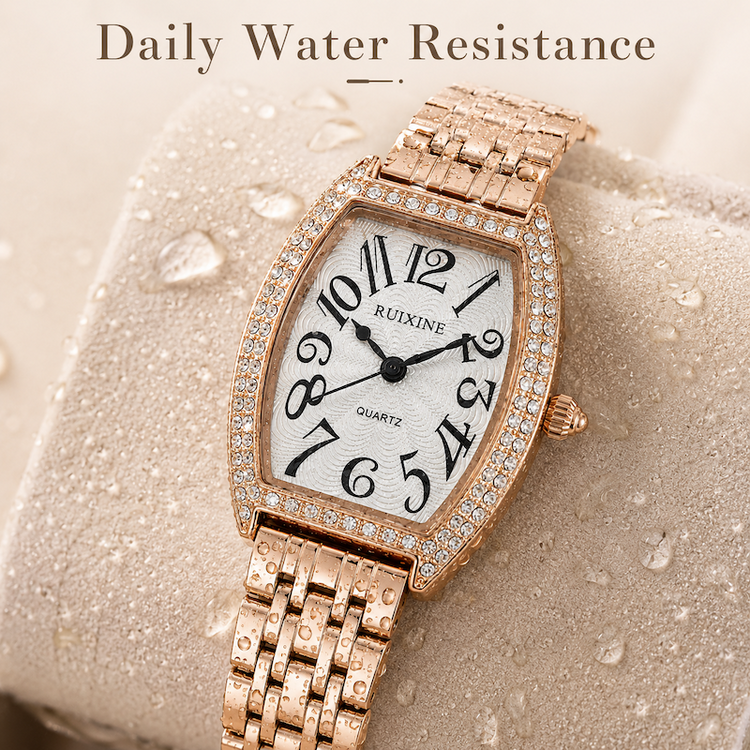 Relógio retangular dourado rosé, pulseira metálica e mostrador branco com pedras